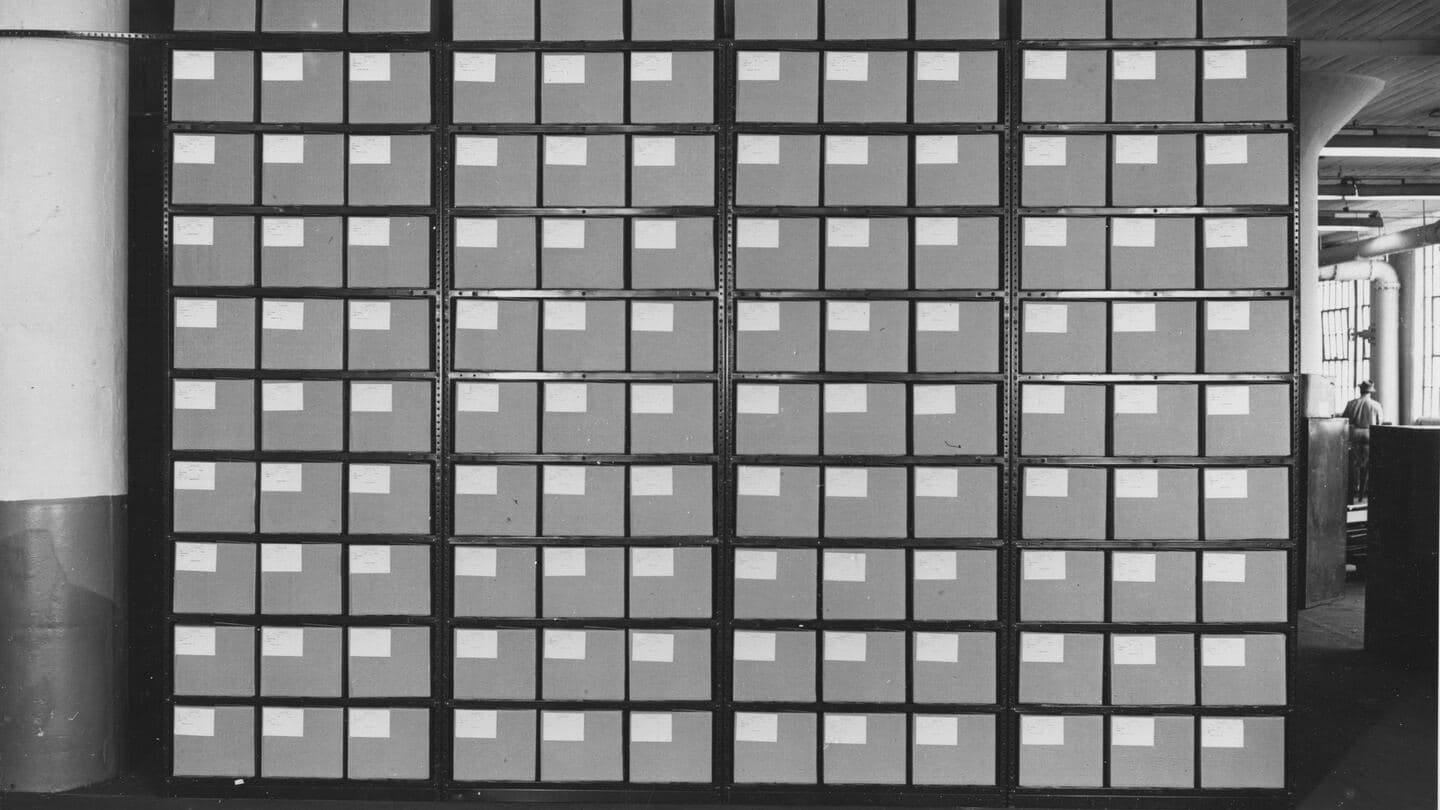 A wall of labeled archive boxes on steel shelving in a federal records center