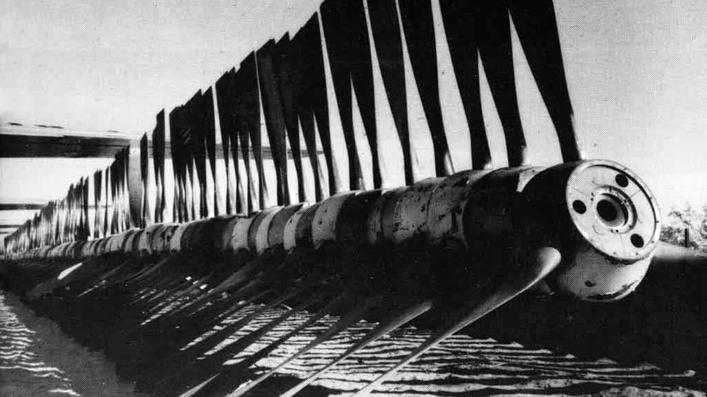 Black-and-white photo of stored aircraft propellers lined up in rows