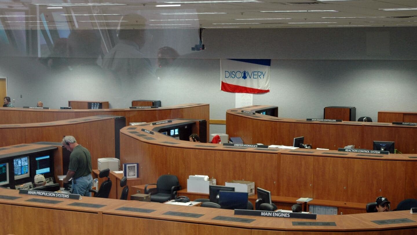 A large operations room with tiered rows of consoles