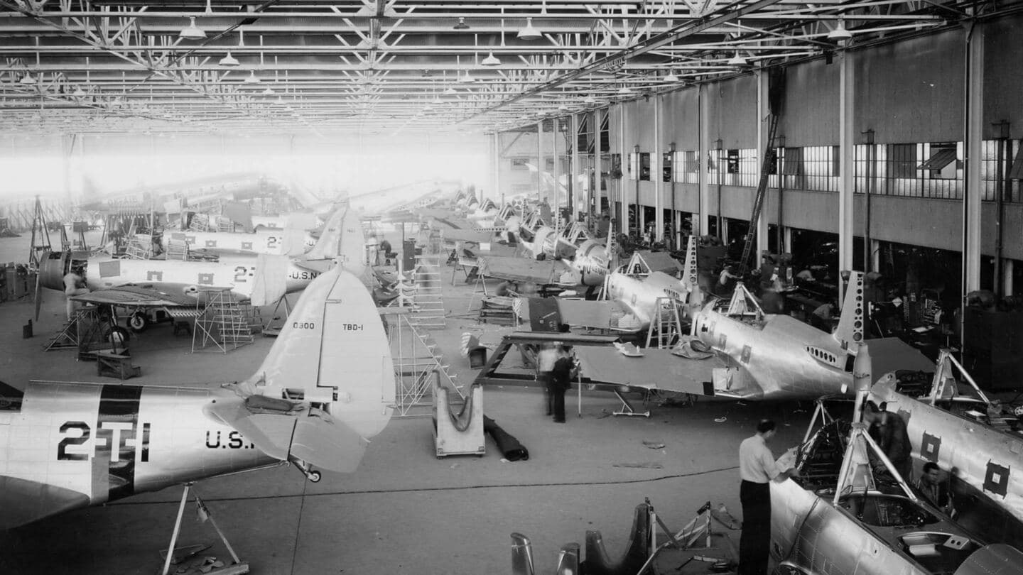 A 1938 aircraft factory floor with rows of Navy torpedo bombers in stages of assembly