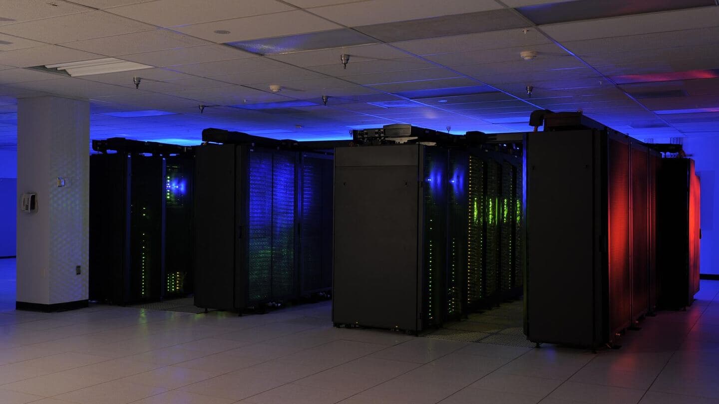 Rows of server cabinets with blue lighting in a data center