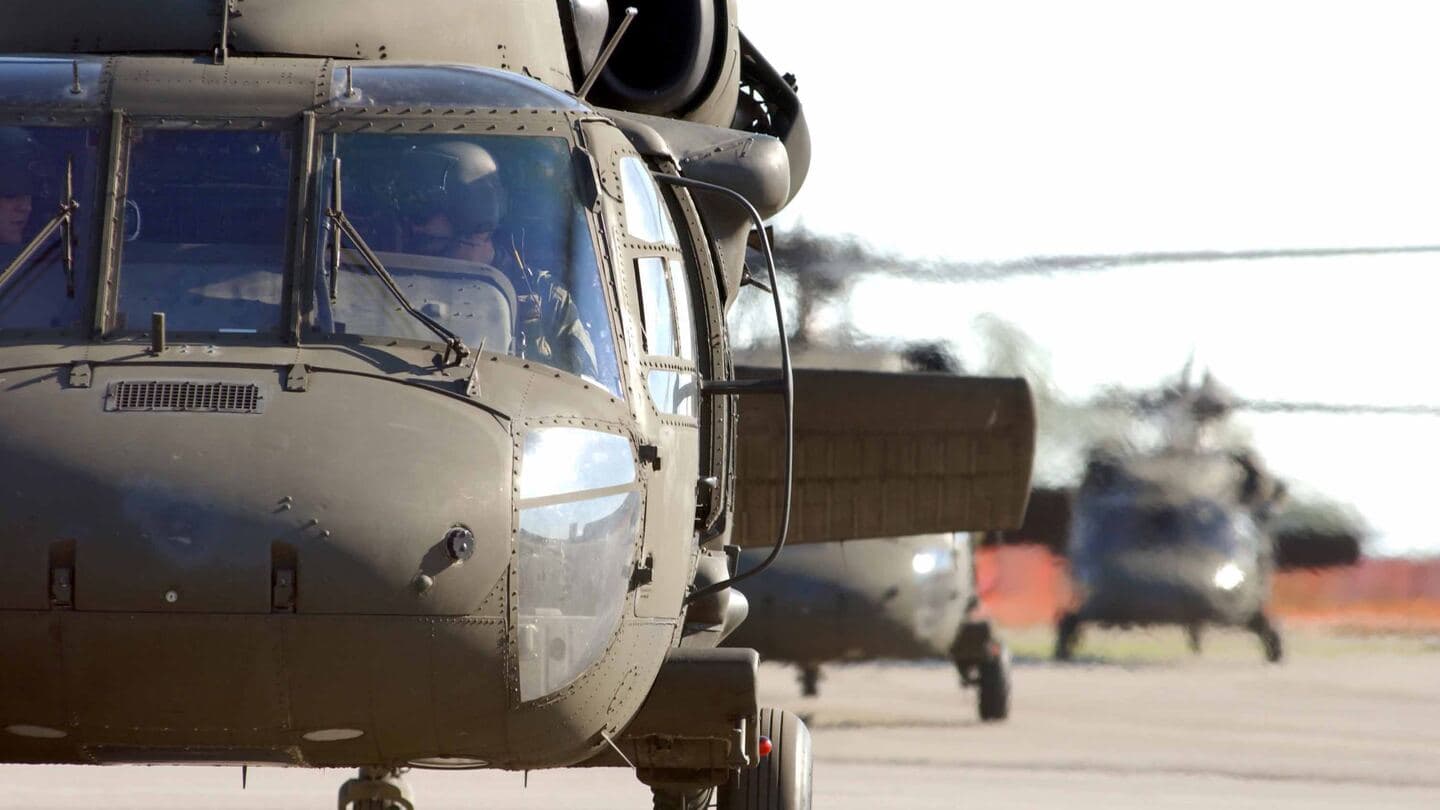 Close view of a UH-60 Black Hawk nose with two more Black Hawks taxiing behind