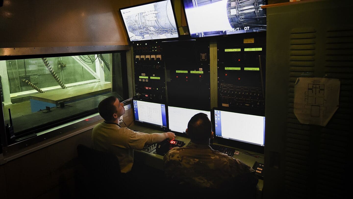 A jet engine running in a test cell, seen from the control room