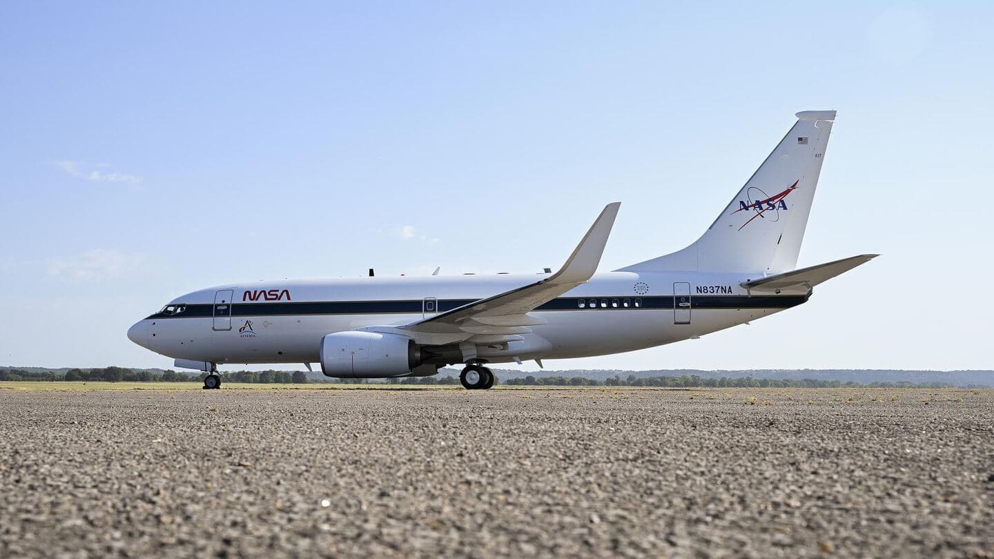 A twin-engine jet airliner in NASA livery on a desert ramp