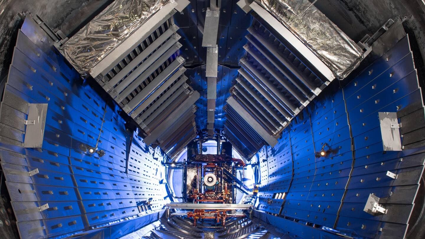 Inside an empty thermal vacuum chamber lit in blue