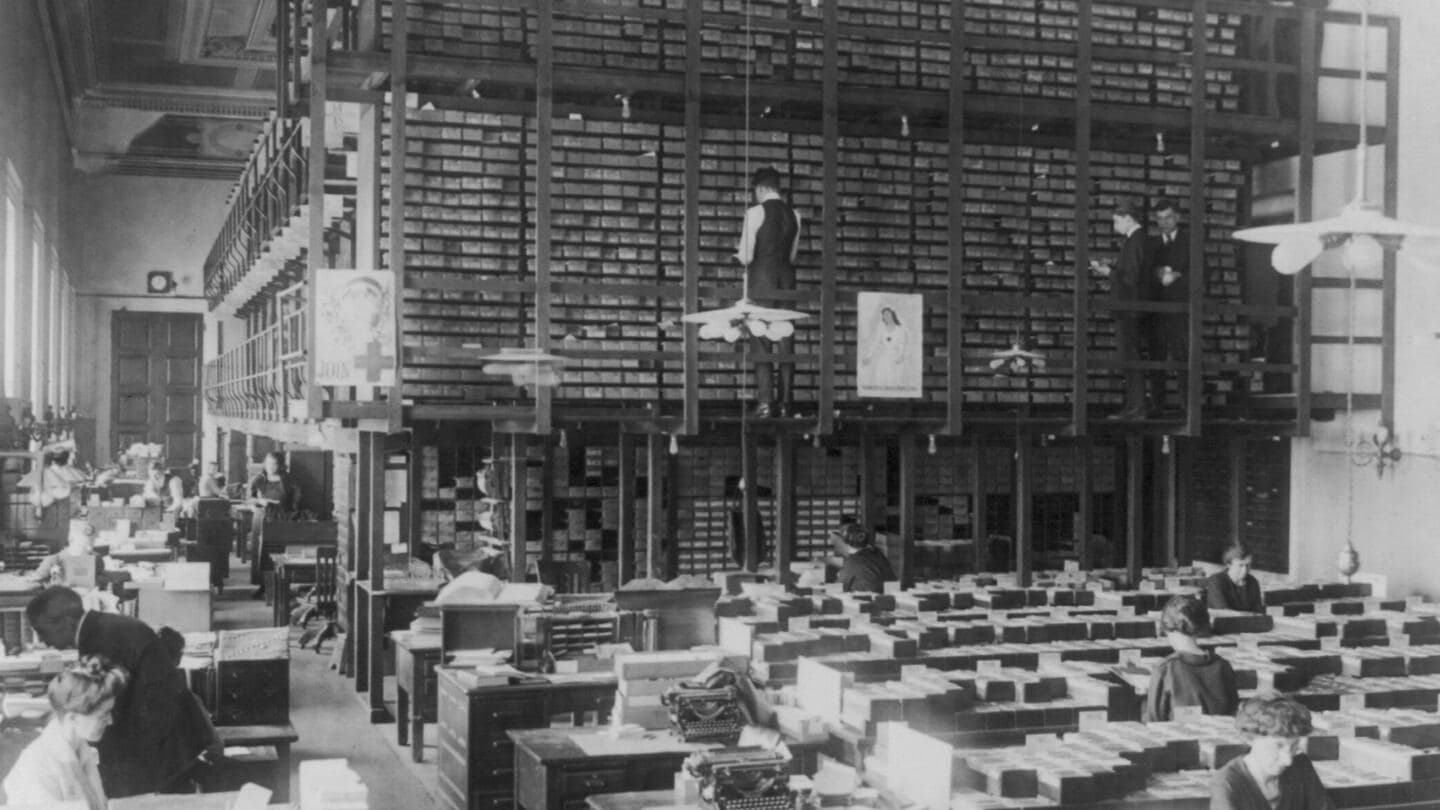 A vast Library of Congress card division room, walls of catalog drawers above rows of busy desks
