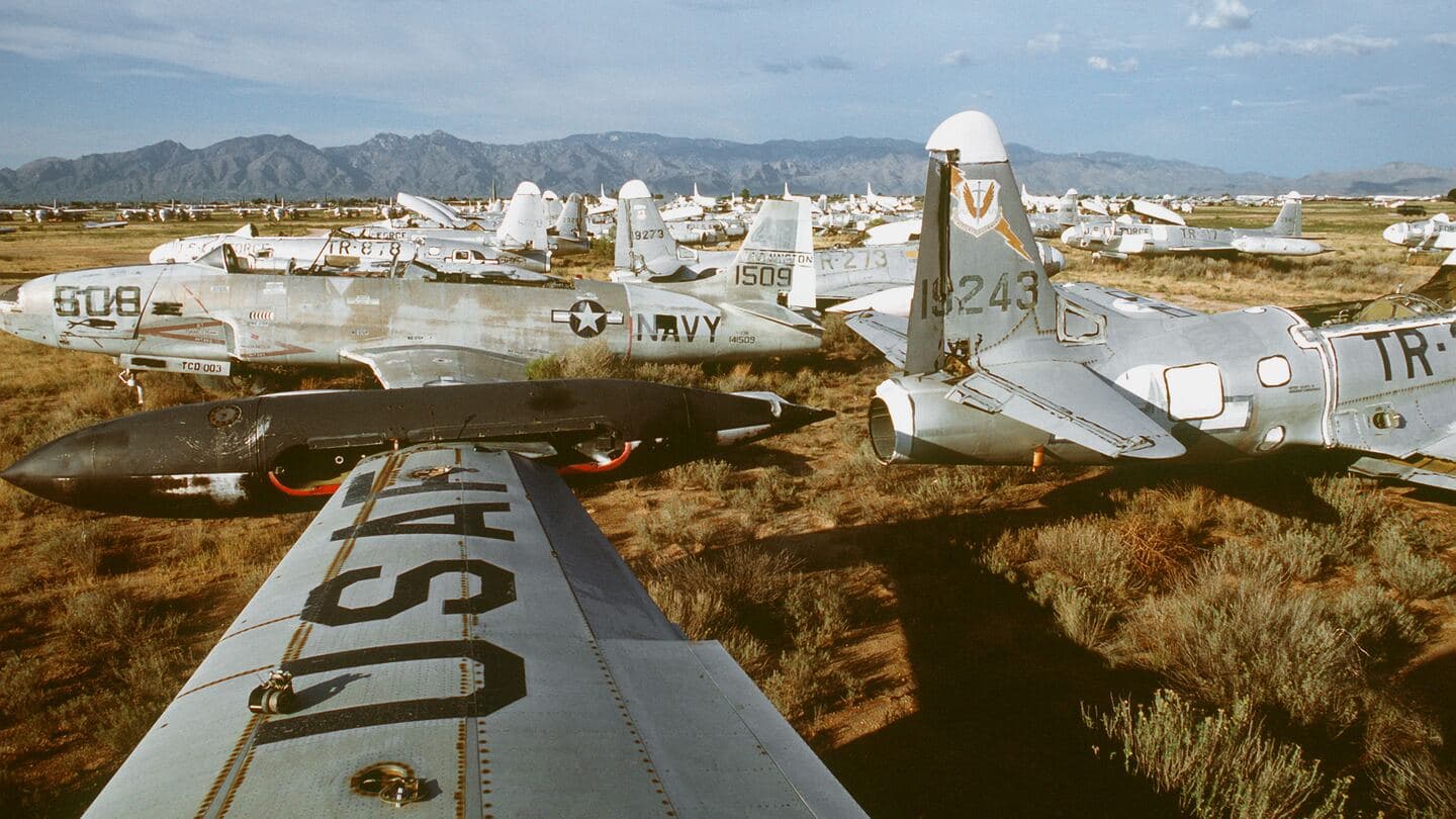Retired T-33 jet trainers stored in rows in the Arizona desert, seen over a USAF-marked wing