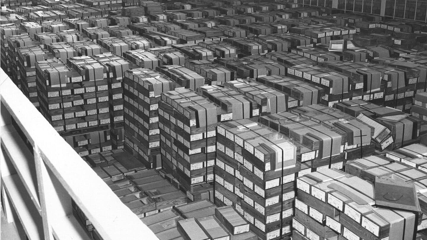 Thousands of record card boxes stacked in rows across a federal records center floor, 1959